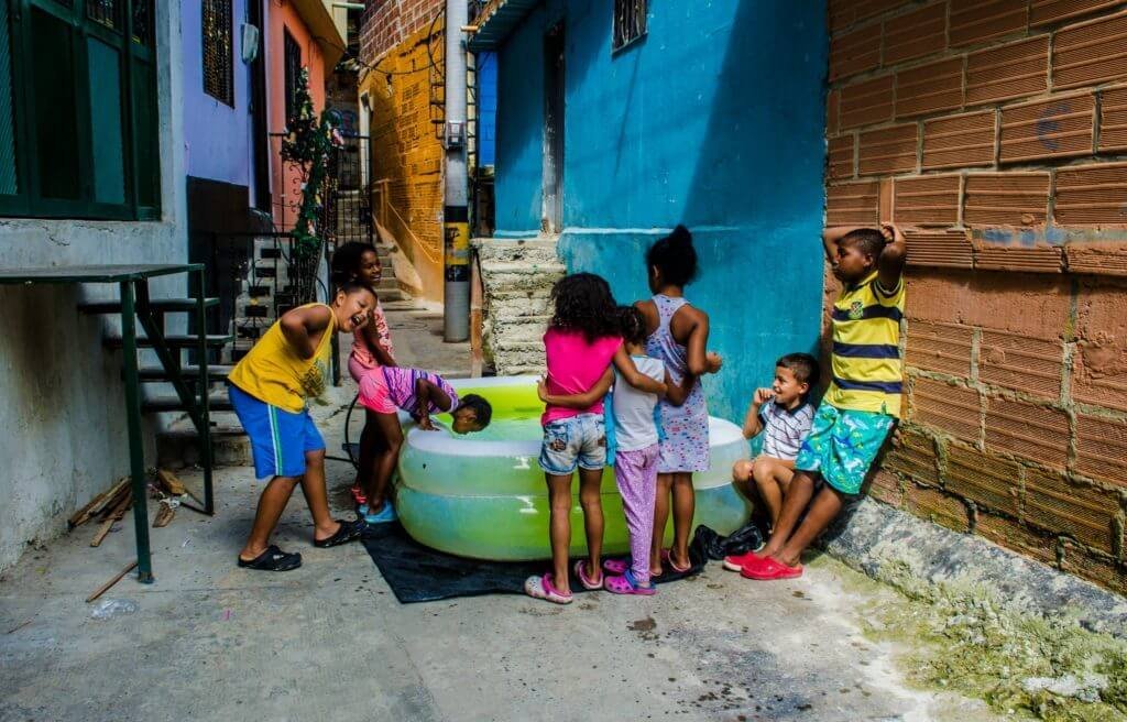 Niños habitantes de la Comuna 13 jugando en un día caluroso. Foto: Germán Moreno.